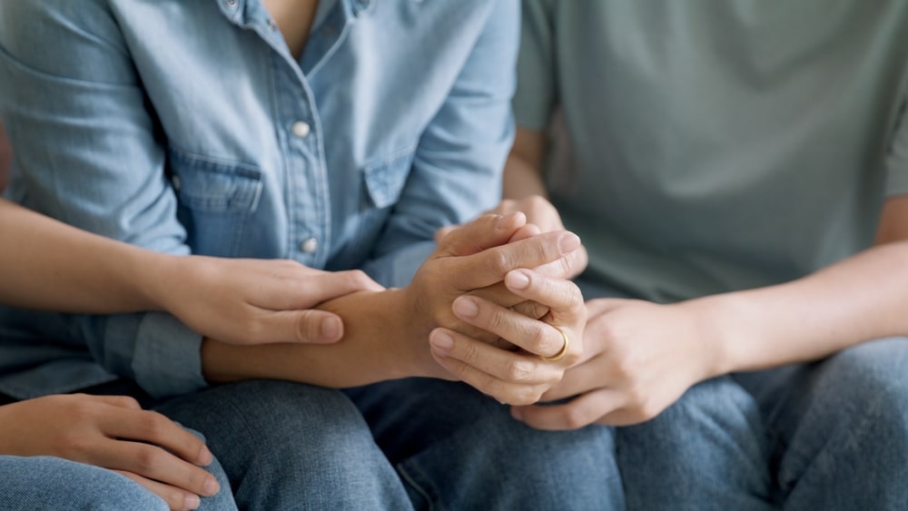 Parent and child holding hands representing family attachment and support