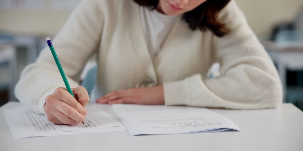 Education,,Exam,And,Person,At,Desk,With,Test,,Paper,And